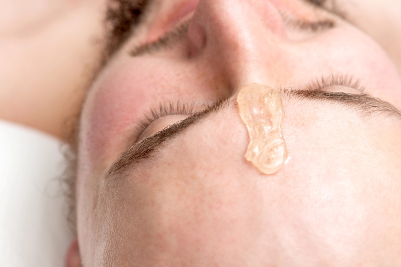 Wax applied to a man's brows during an eyebrow appointment