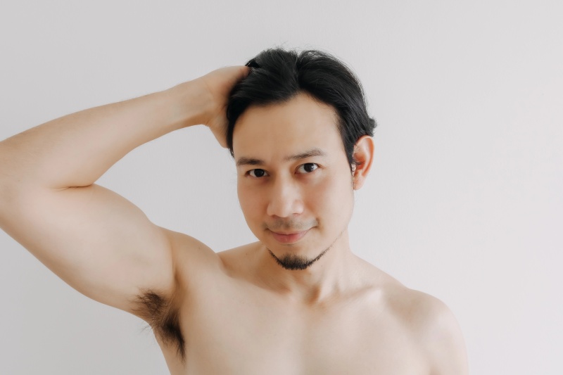 Wax application during a men's body waxing appointment