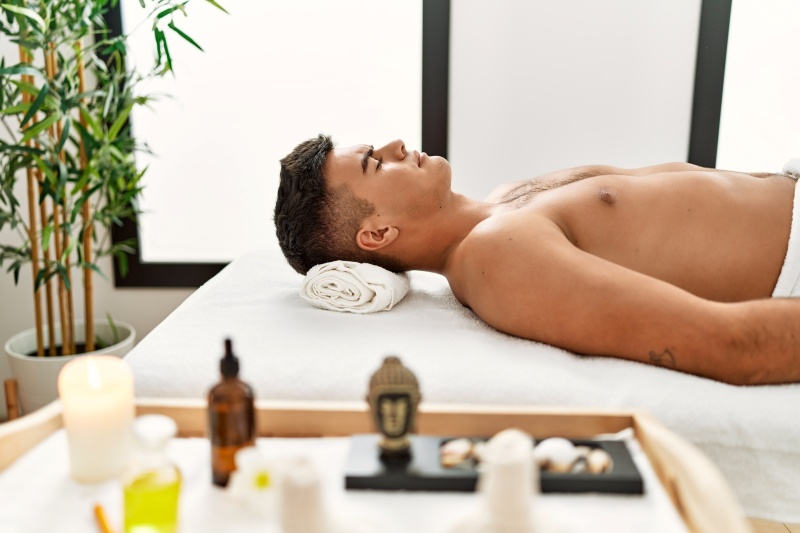 Man getting his back waxed for long-lasting smooth skin
